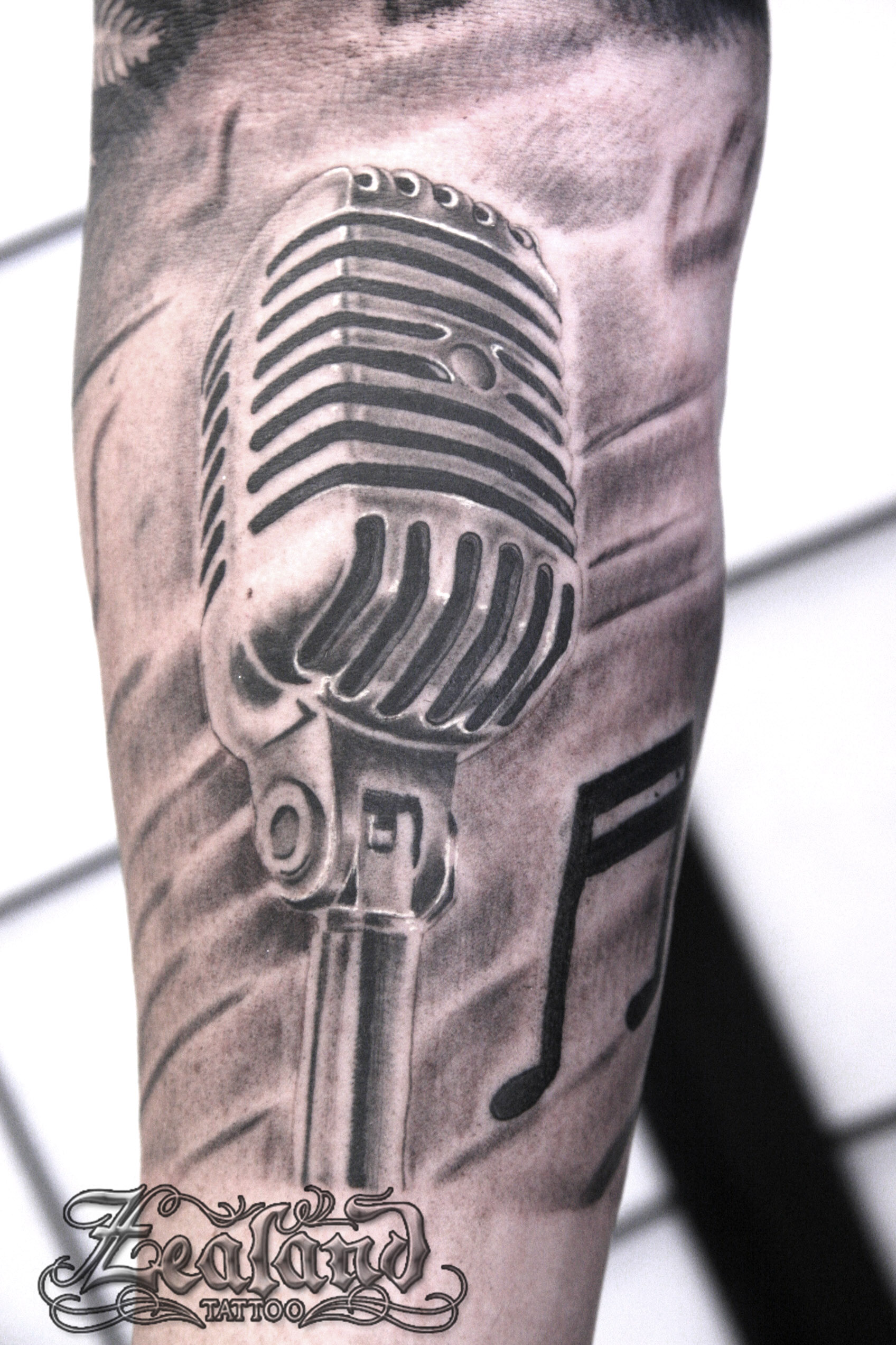 Single needle microphone tattoo on the right inner arm