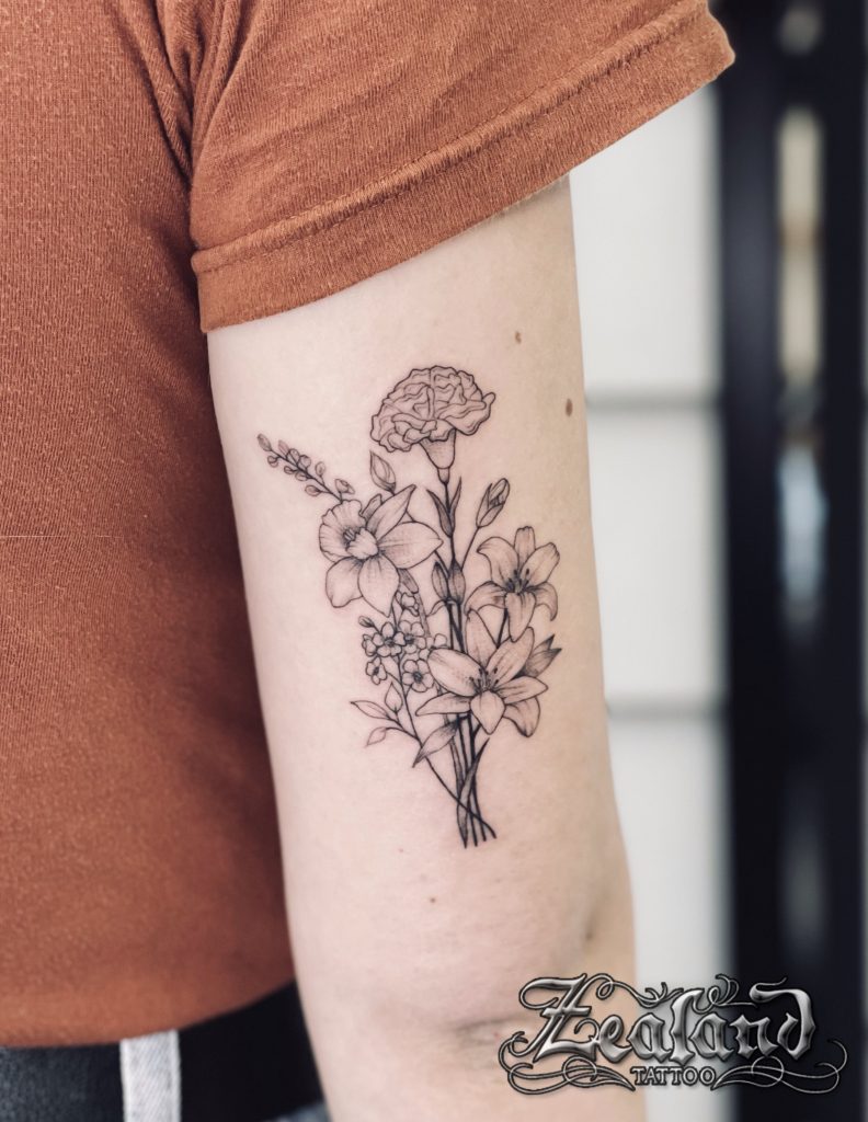Peony flower tattoos on the right upper arm